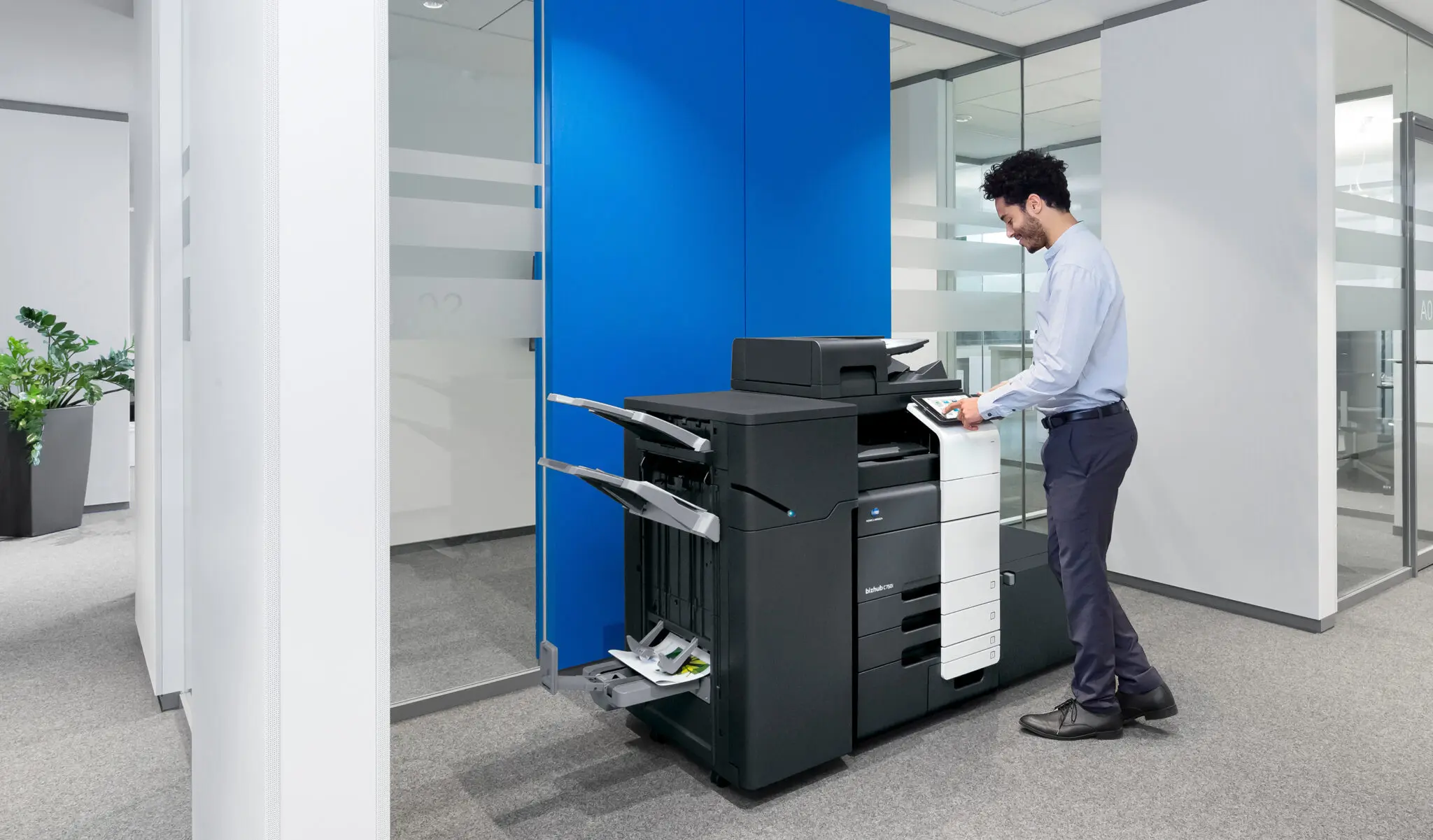 Worker standing at multifunction printer